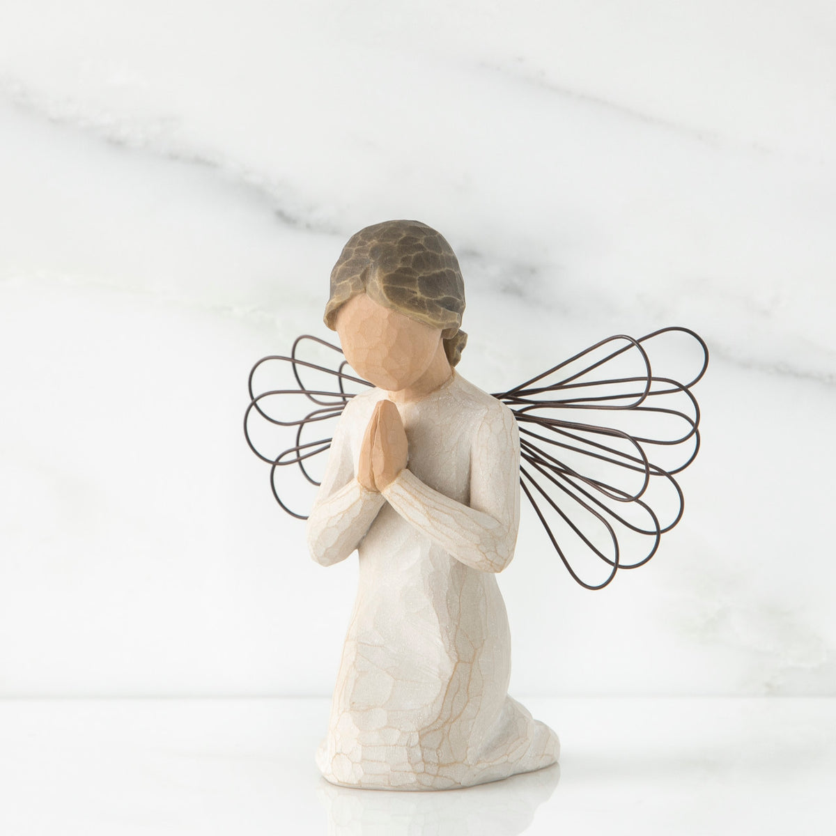 Small faceless girl kneeling praying with black wire angel wings