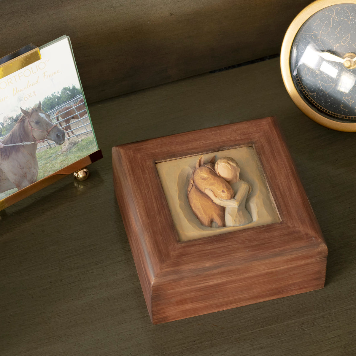 Willow Tree Quiet Strength Memory Box, 4.75” sq x 2”h hand-painted red-brown wood box with bas-relief resin carving of girl in green dress, arms embracing horse on hinged lid