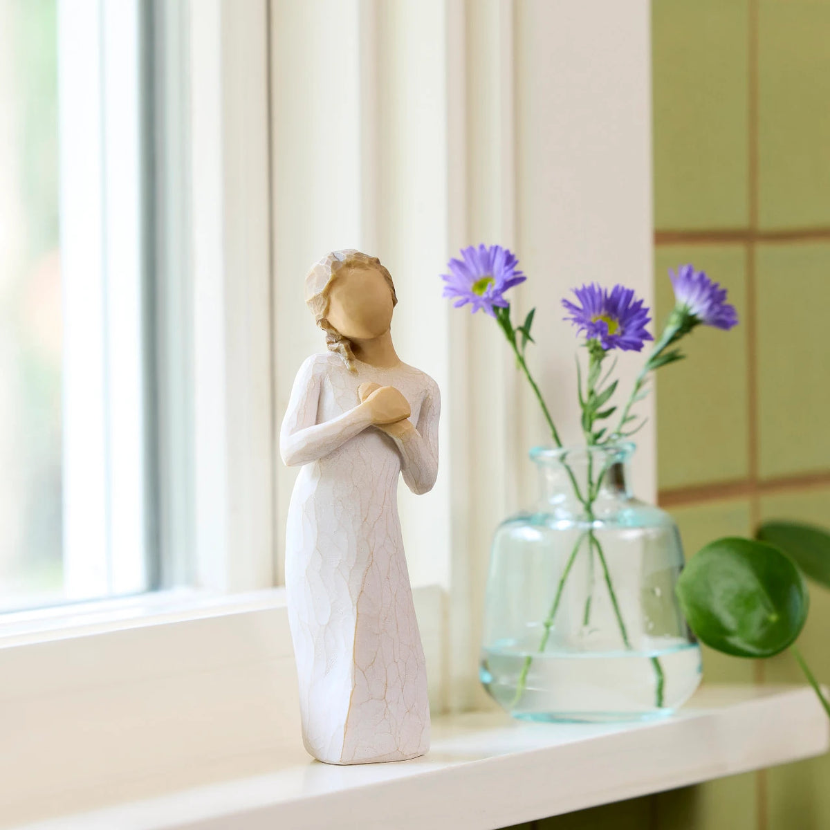 Willow Tree Here for You, 5”h hand-painted standing figure in cream dress, hands to heart in empathetic gesture, on bright windowsill