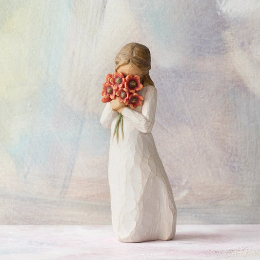 Willow Tree Surrounded by Love, 5"h hand-painted standing resin figure in cream dress, holding large bouquet of red-orange poppies up to face, in front of pastel painting