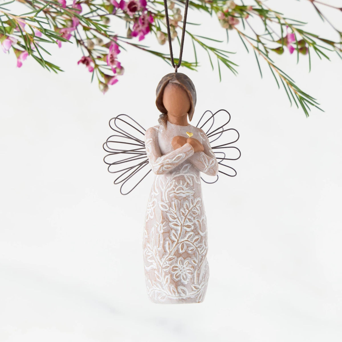 Front: Angel Ornament with wire wings, darker skin, arms crossed over gold heart, dress carved with symbols of remembrance