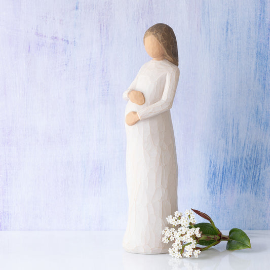 Willow Tree Cherish, 8.5”h hand-painted standing pregnant resin figure in cream dress, both hands on belly, in front of light blue painting