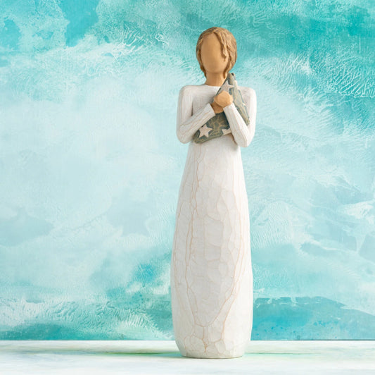 Willow Tree Hero, 9.5”h hand-painted standing resin figure in cream dress holding folded American flag in her arms,  in front of aqua painting