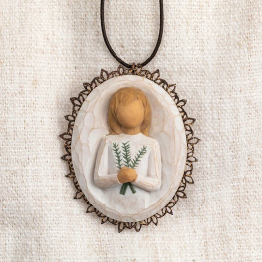 Oval bas-relief carving of figure holding sprig of rosemary, edged in pierced-metal filigree with brown elastic ornament loop