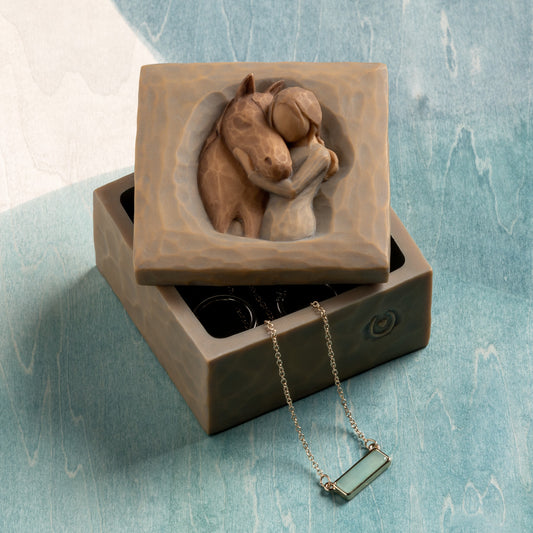 Willow Tree Quiet Strength Keepsake Box, 3”sq x 2.5”h hand-painted resin box with removable lid off to one side. Lid has bas-relief carving of girl in cream dress, arms around neck of reddish-color horse