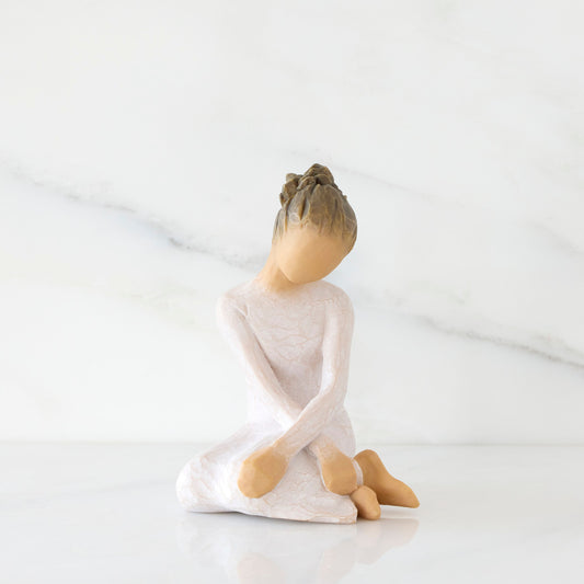 Front view: seated figure in cream dress with crossed arms
