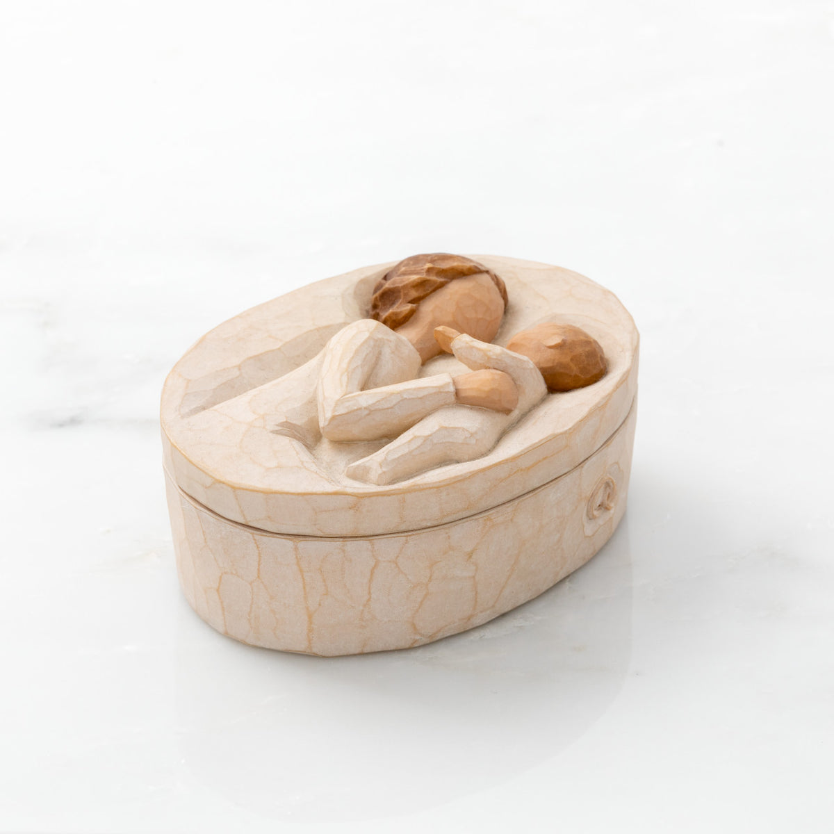 Willow Tree Grandmother Keepsake Box, 3.4" oval x 1.5" h hand-painted resin box with removable lid. Lid has bas-relief carving of older woman in cream dress, holding up baby, inside of box has sentiment