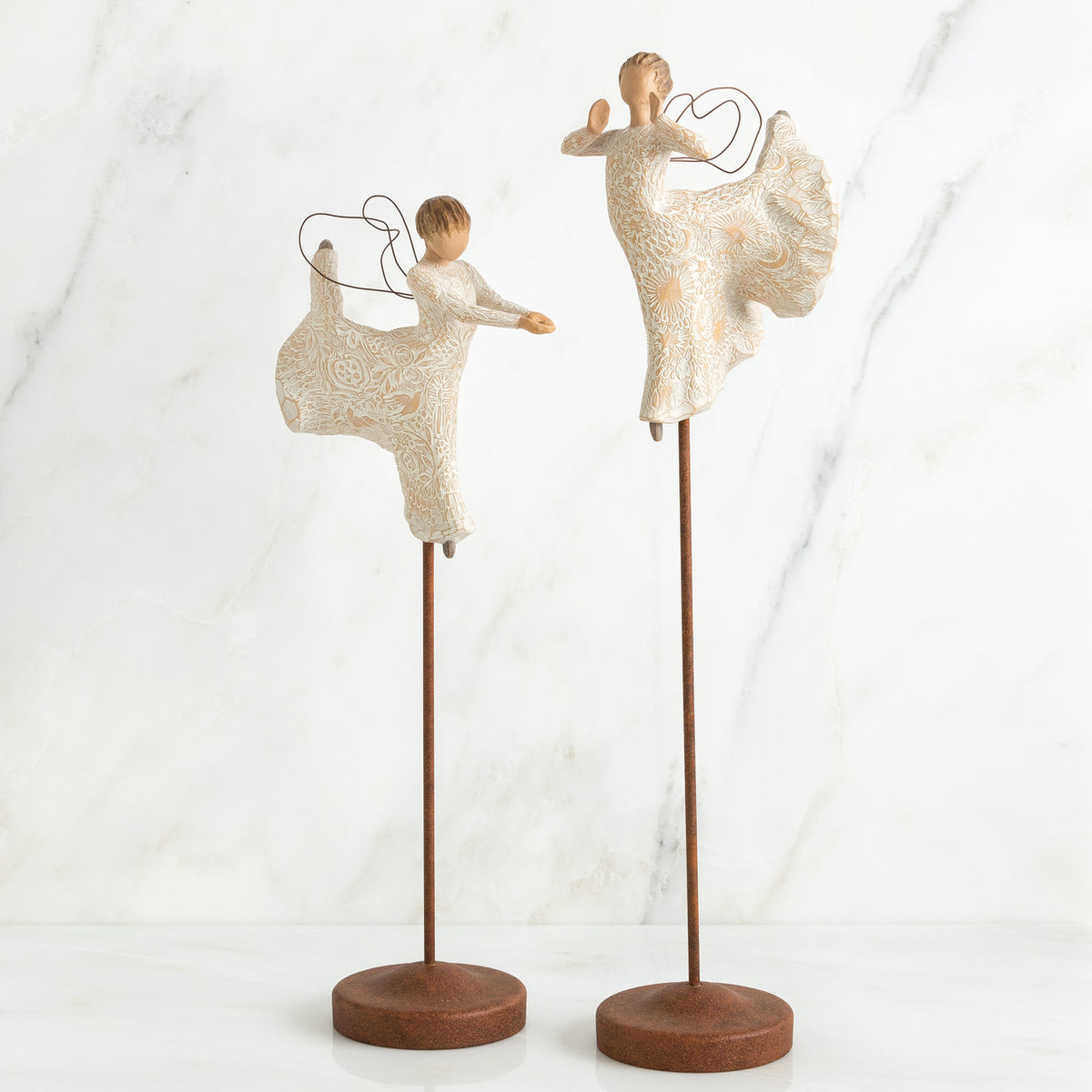 Set of two angel figurines in white dresses danging on wooden stands