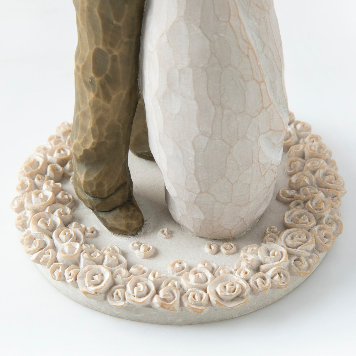 Close view of round cream plaque with man and woman's legs on them