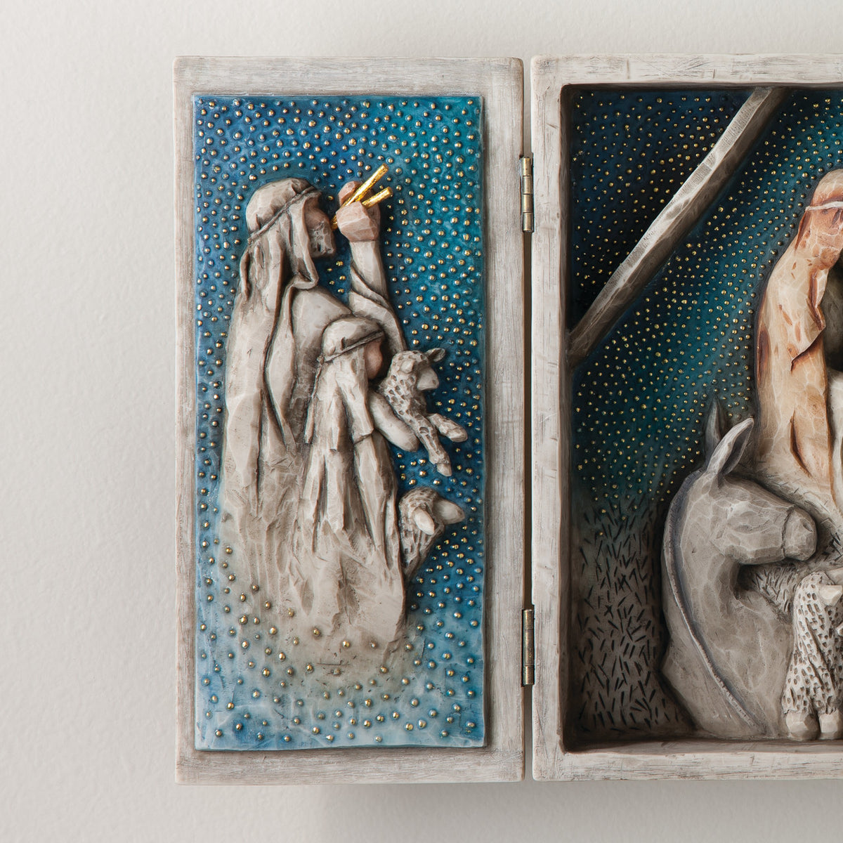 A hinged resin box, done in a Willow Tree format that tells the story of the Nativity