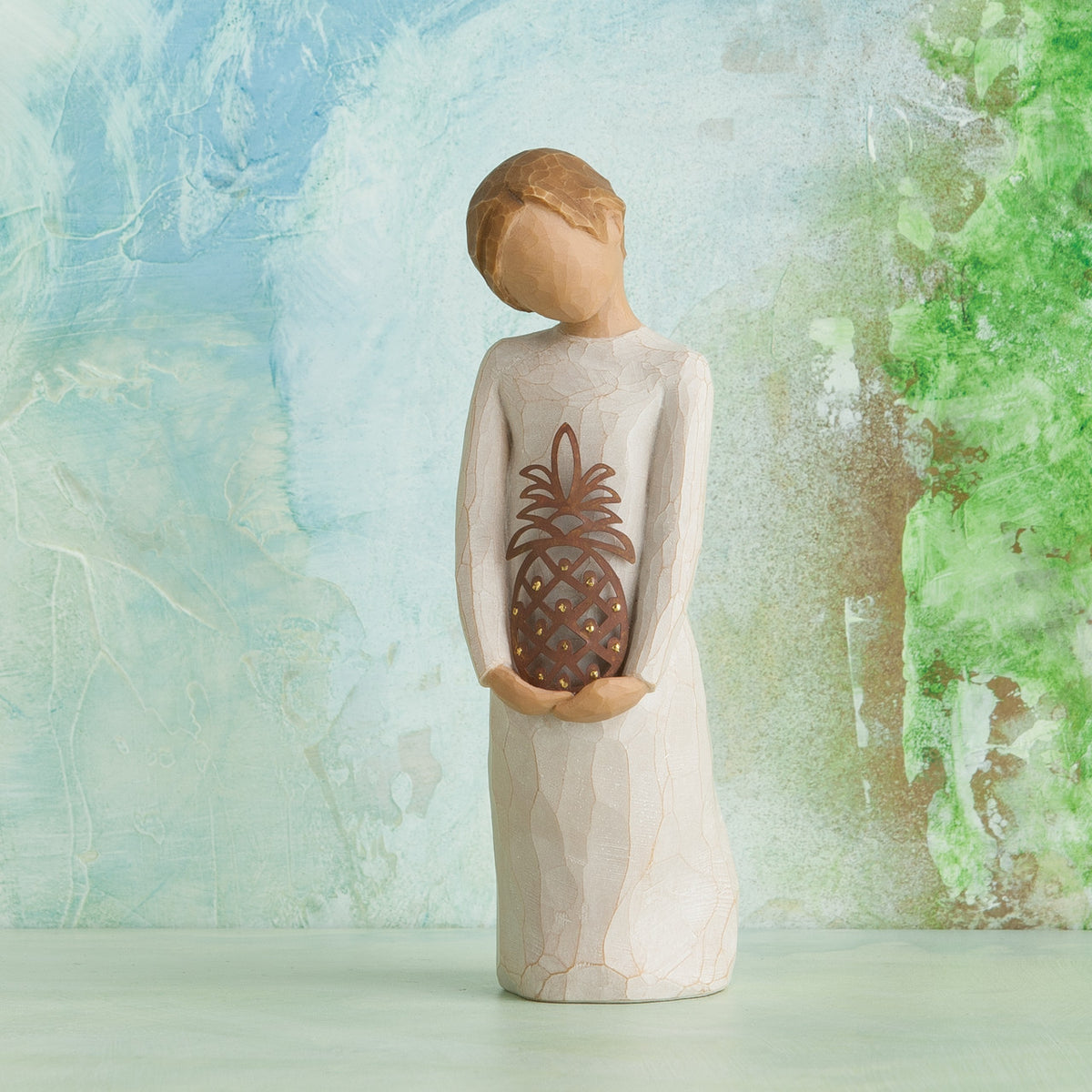 Willow Tree Gracious, 5.5" hand-painted standing resin figure in cream dress, holding pierced-metal pineapple, in front of pale blue painting