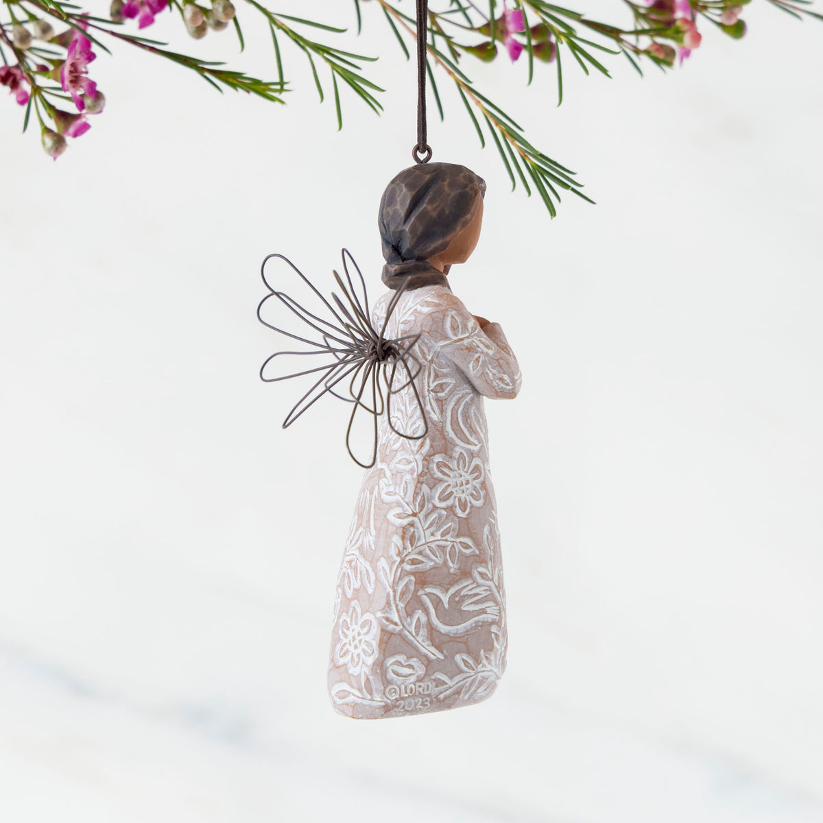 Right Side: Angel Ornament with wire wings, darker skin, dress carved with symbols of remembrance