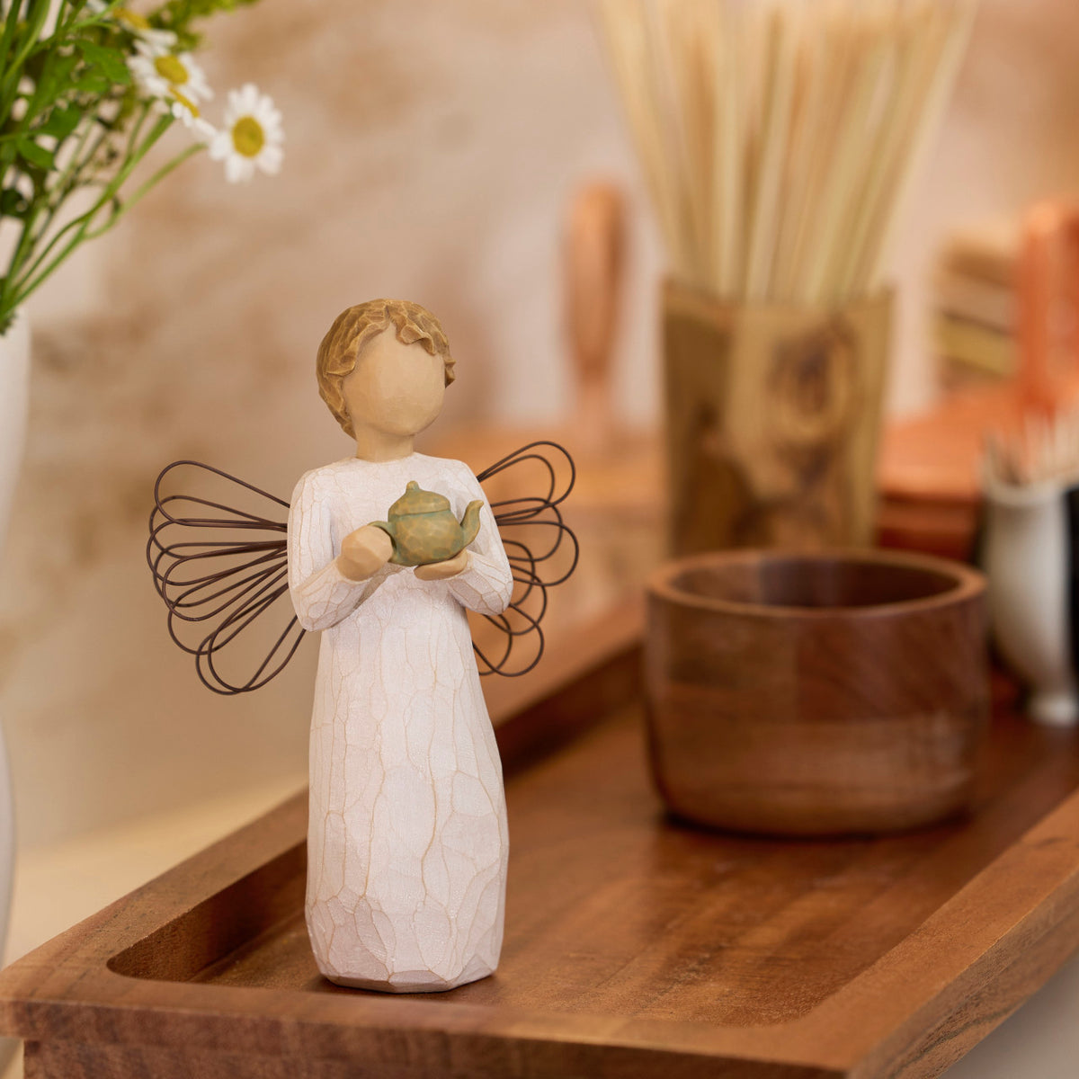 Willow Tree Angel of the Kitchen, 5.5”h hand-painted standing resin figure in cream dress with wire wings, holding green teapot, on dark wood tray