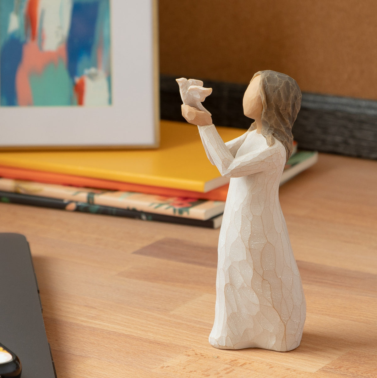 Willow Tree Soar, 5”h hand-painted standing figure in cream dress holding white dove in outstretched hands, on wooden desk