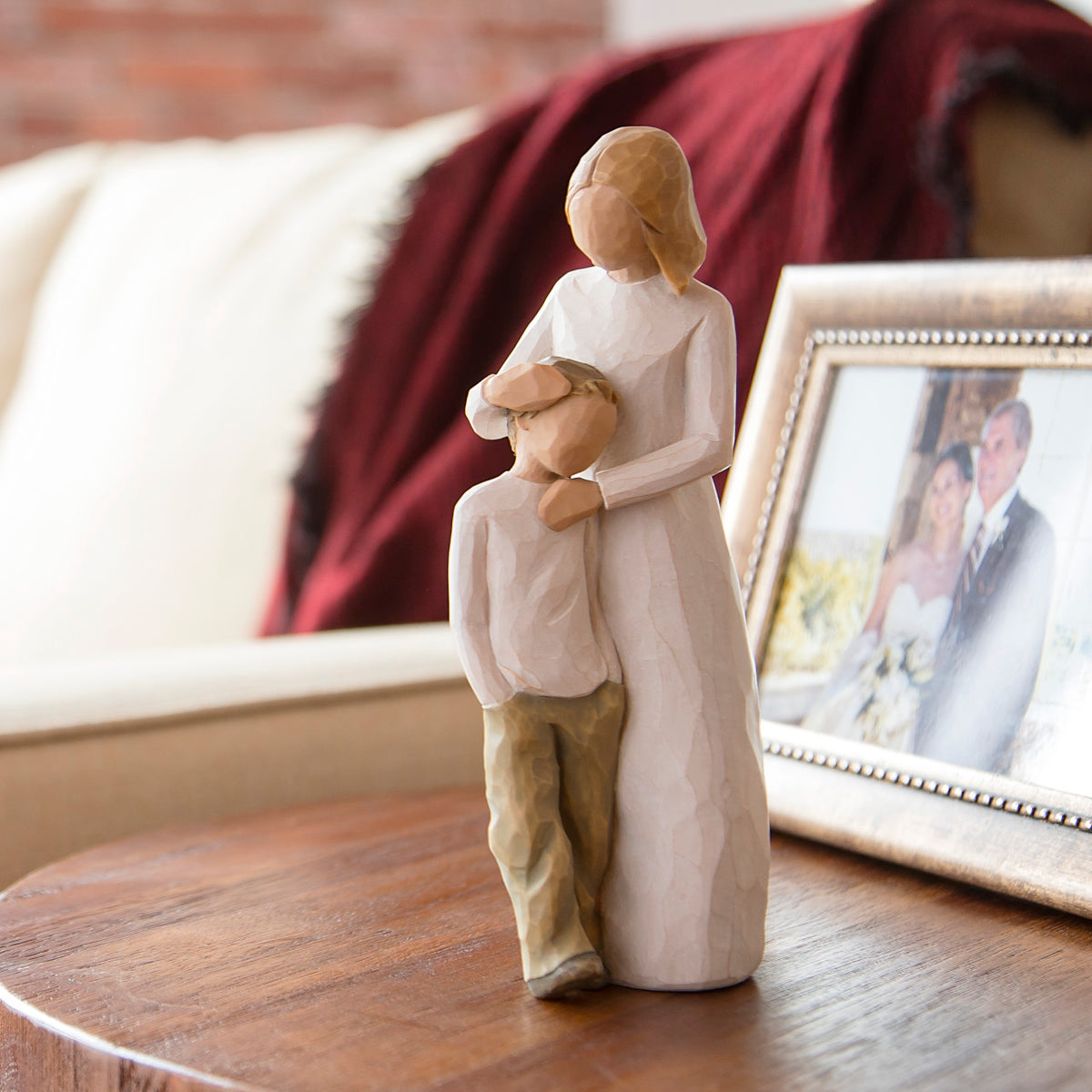 Willow Tree Mother and Son, 8”h hand-painted standing resin figure with arms around young boy, both in neutral clothing, on bedside table