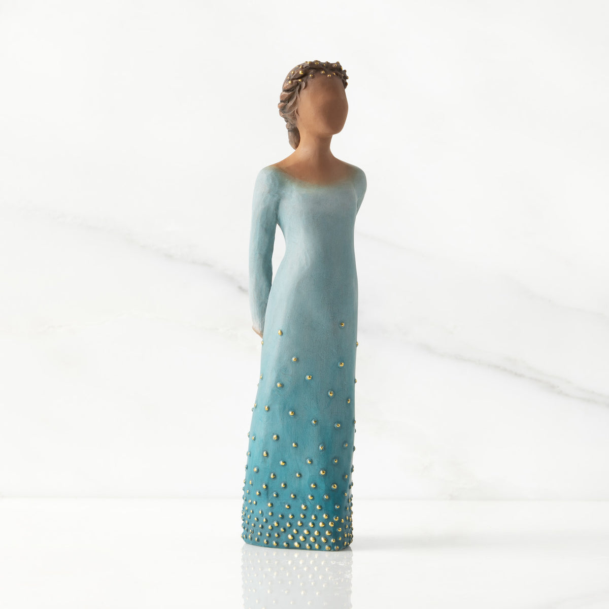 Facing center/right: Darker-skin figure, arms clasped behind back, hair and deep blue ombré garment dotted with gold leaf