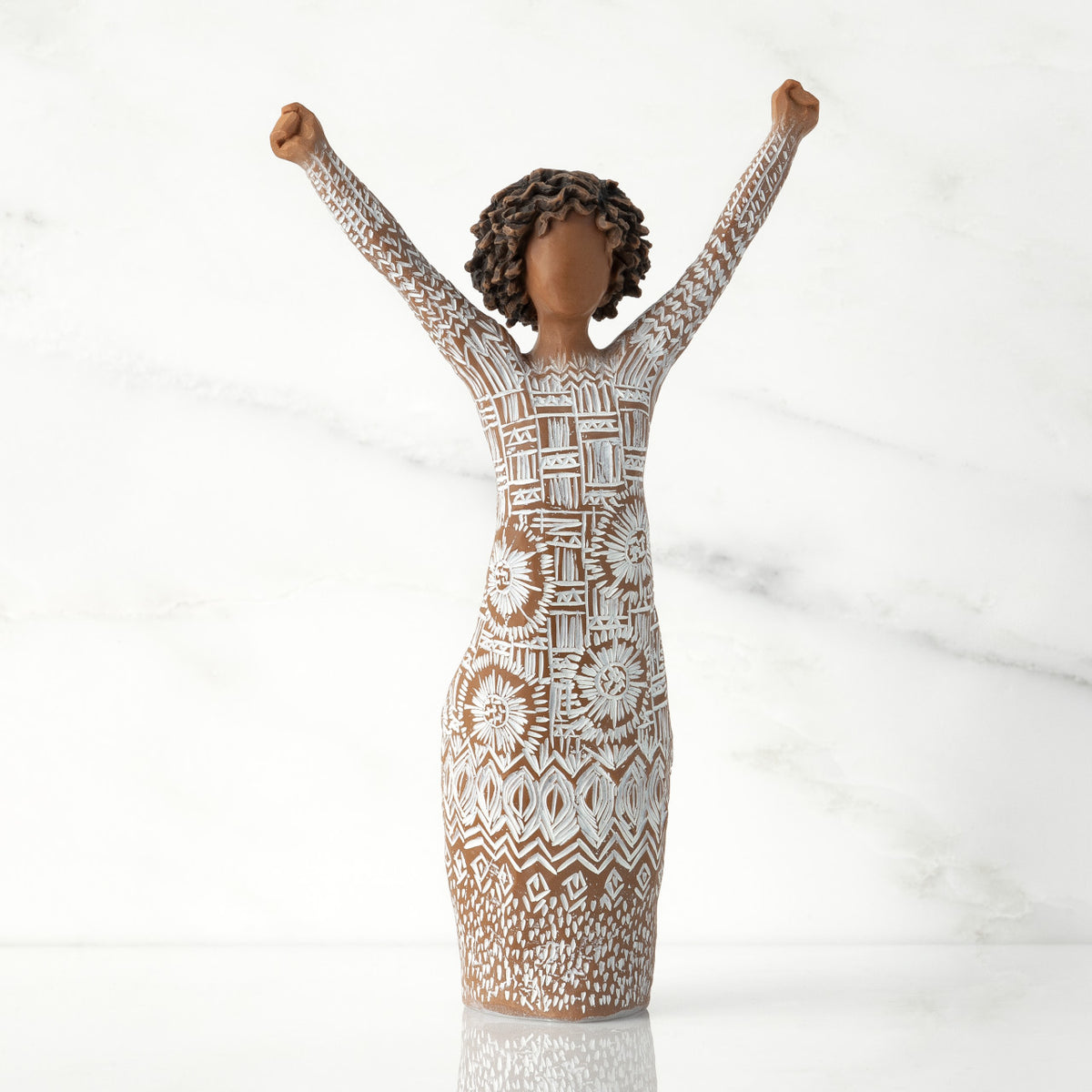 Front view of figure with natural hairstyle, arms raised overhead, dress etched with African textile patterns